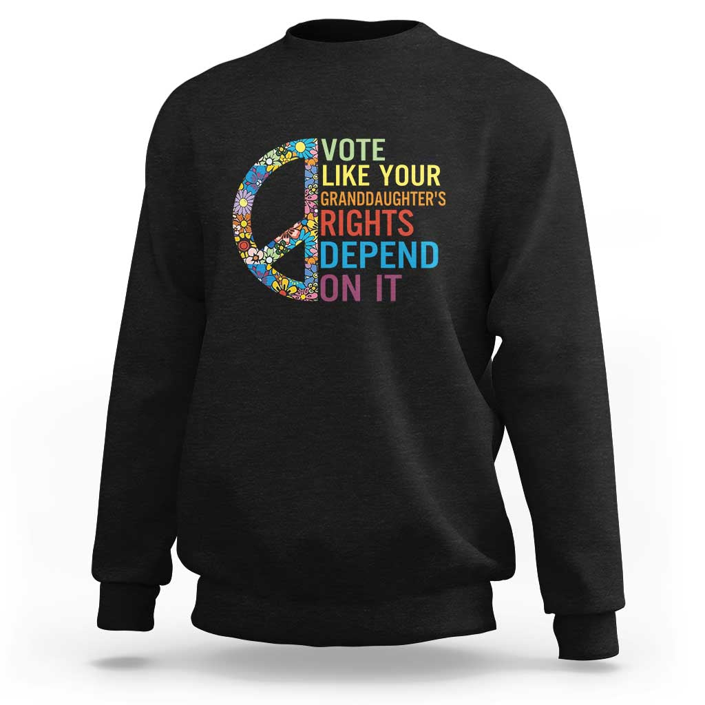 Black crewneck graphic sweatshirt with floral peace sign and voting text design