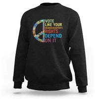 Black crewneck graphic sweatshirt with floral peace sign and voting text design
