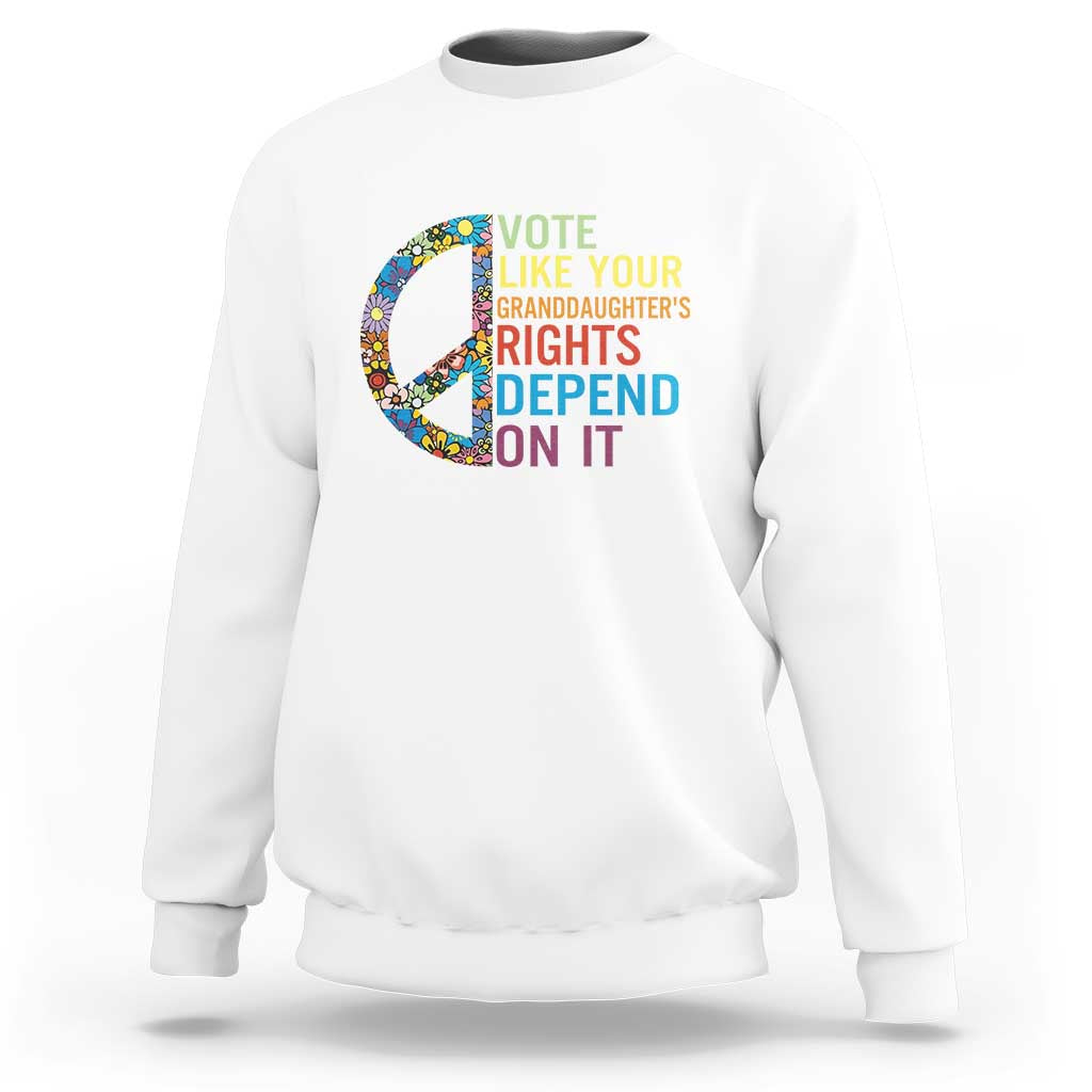 White crewneck graphic sweatshirt with floral peace sign and voting text design