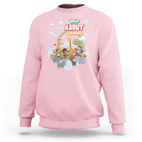 Light pink crewneck sweatshirt with colorful zoo animal graphic on front