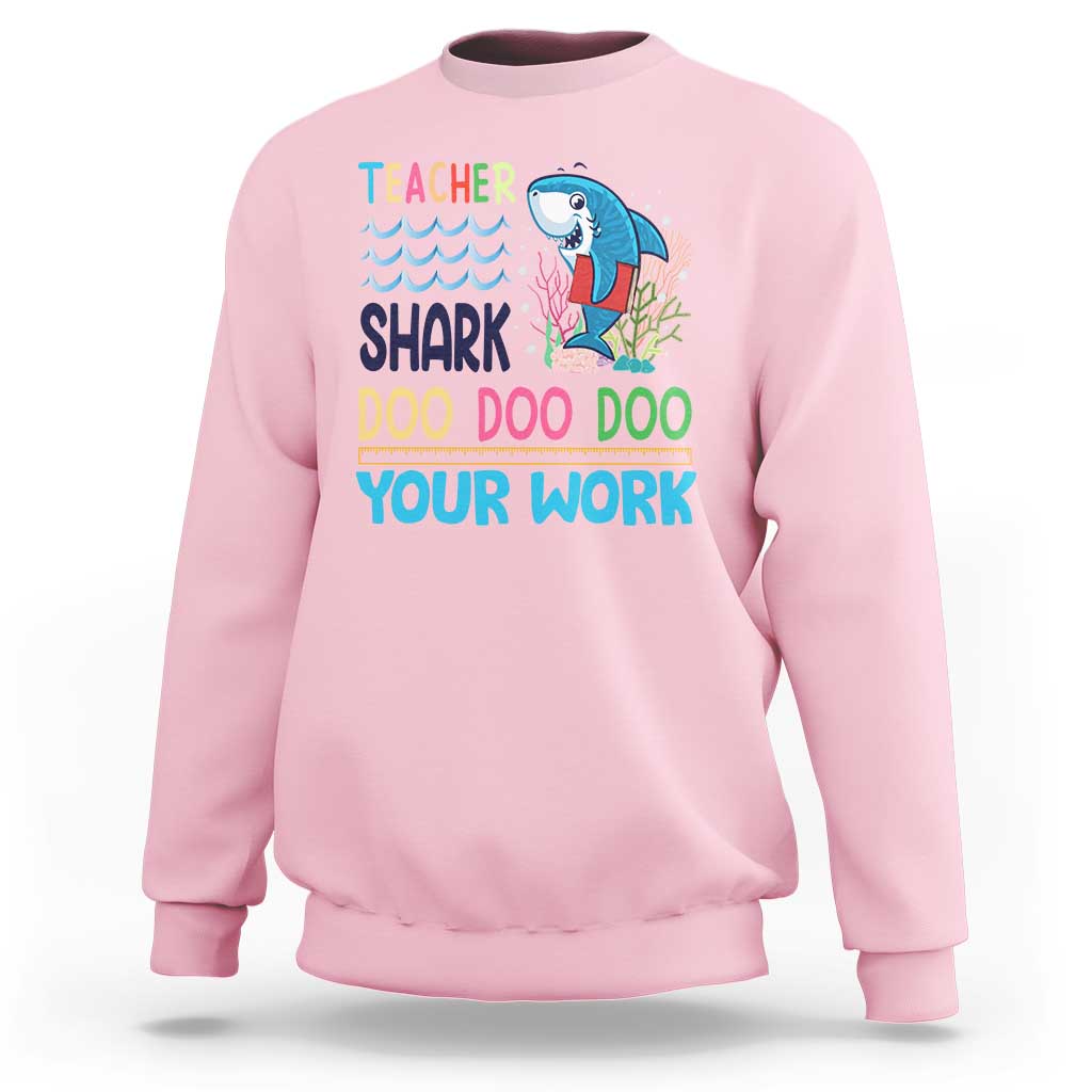 Light pink crewneck sweatshirt with teacher shark 'Doo Doo Doo Your Work' graphic
