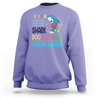 Violet crewneck sweatshirt with teacher shark 'Doo Doo Doo Your Work' graphic