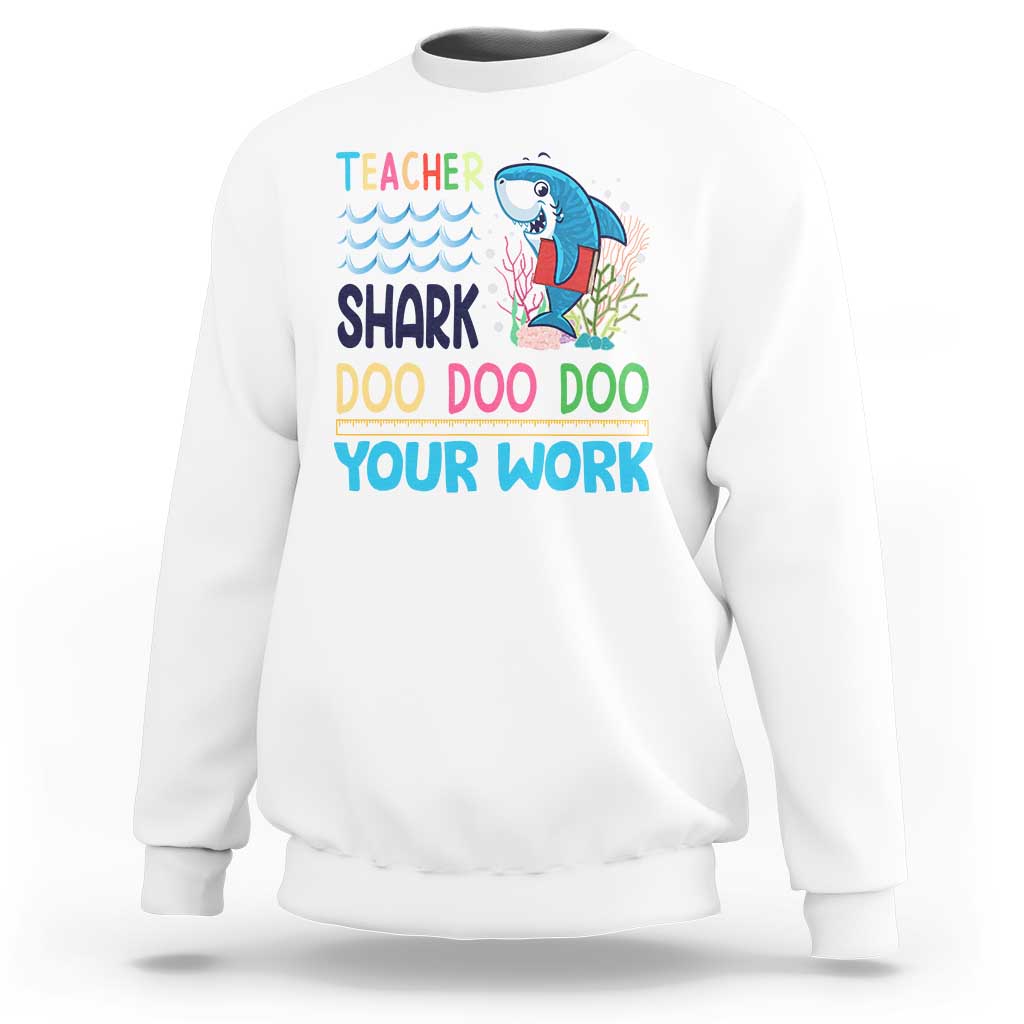 White crewneck sweatshirt with teacher shark 'Doo Doo Doo Your Work' graphic