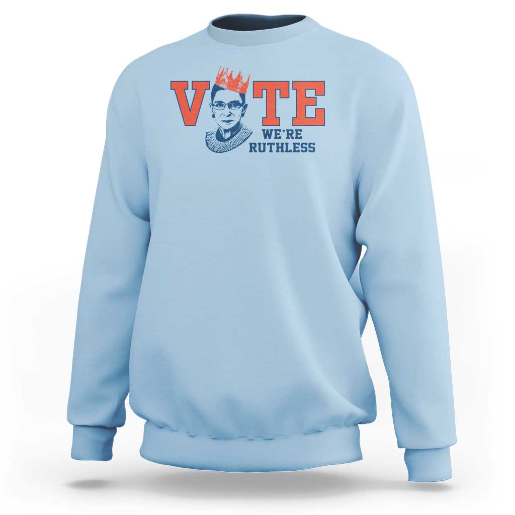 Light blue women's crewneck sweatshirt with 'VOTE' and 'WE'RE RUTHLESS' chest graphic.