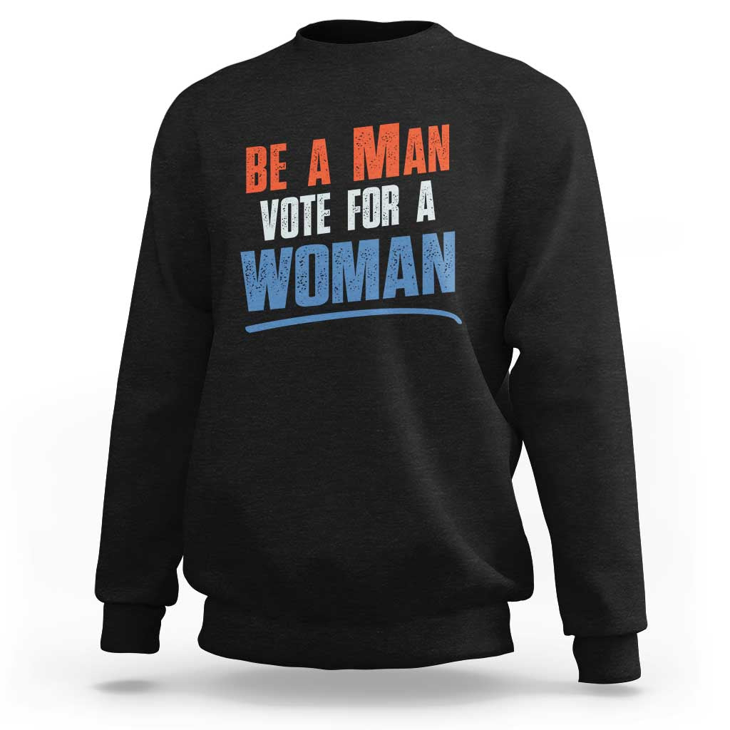 Black sweatshirt with 'BE A MAN VOTE FOR A WOMAN' graphic