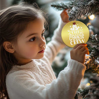 Gold round ornament hanging on a Christmas tree branch, “THE COOKIE CREW” graphic