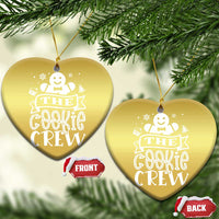 Gold heart-shaped ornament hanging with “THE COOKIE CREW” design