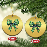 Two round gold Christmas ornaments with green bow and gold star, hanging from gold strings.