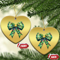 Two heart-shaped gold Christmas ornaments with green bow and gold star, hanging from gold strings.