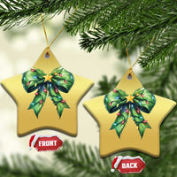 Two star-shaped gold Christmas ornaments with green bow and gold star, hanging from gold strings.