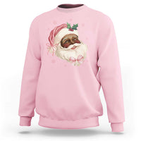 Light pink crewneck sweatshirt with cartoon Santa face and pink bow graphic on chest