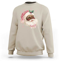 Sand crewneck sweatshirt with cartoon Santa face and pink bow graphic on chest