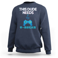 Blue crewneck sweatshirt with “THIS DUDE NEEDS” controller graphic and V-BUCKS text