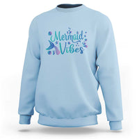 Light blue crewneck sweatshirt with mermaid tail graphic and “Mermaid Vibes” print