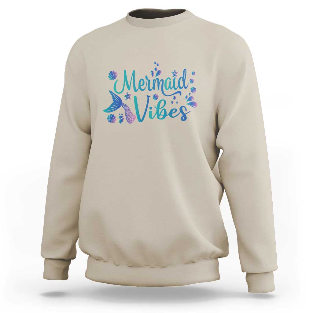 Sand/beige crewneck sweatshirt with mermaid tail graphic and “Mermaid Vibes” print