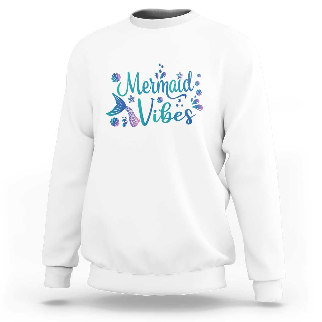 White crewneck sweatshirt with mermaid tail graphic and “Mermaid Vibes” print