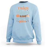 Light blue sweatshirt with 'Thick Thighs and Pumpkin Pies' graphic, long sleeves