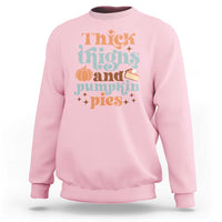 Light pink sweatshirt with 'Thick Thighs and Pumpkin Pies' graphic, long sleeves