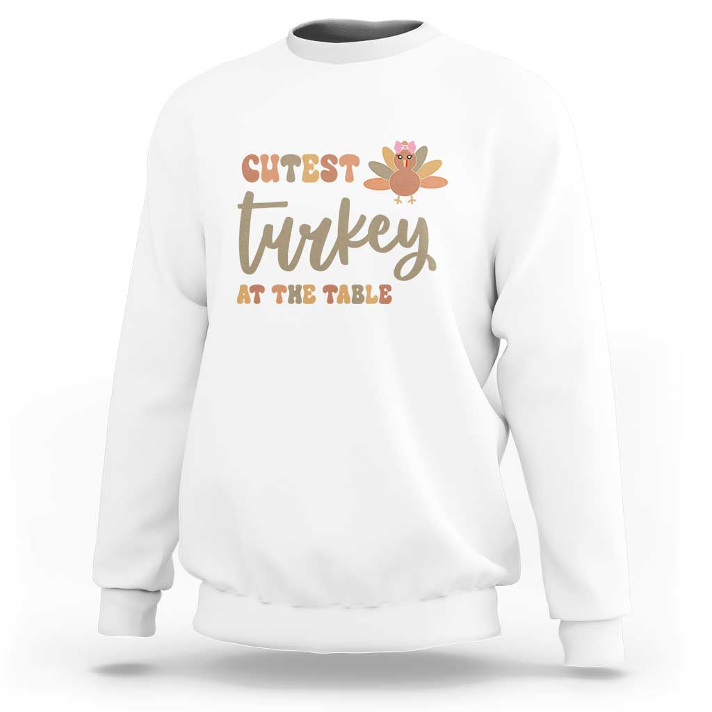 White sweatshirt with "Cutest Turkey At The Table" turkey graphic