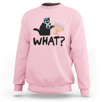 Light pink crewneck sweatshirt with black cat Hanukkah graphic and bold “WHAT?” text