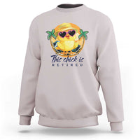 White sweatshirt with cartoon chick graphic and 'This chick is retired' text.