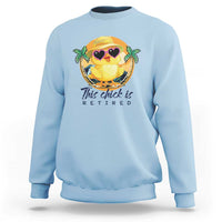 Light blue sweatshirt with cartoon chick graphic and 'This chick is retired' print.