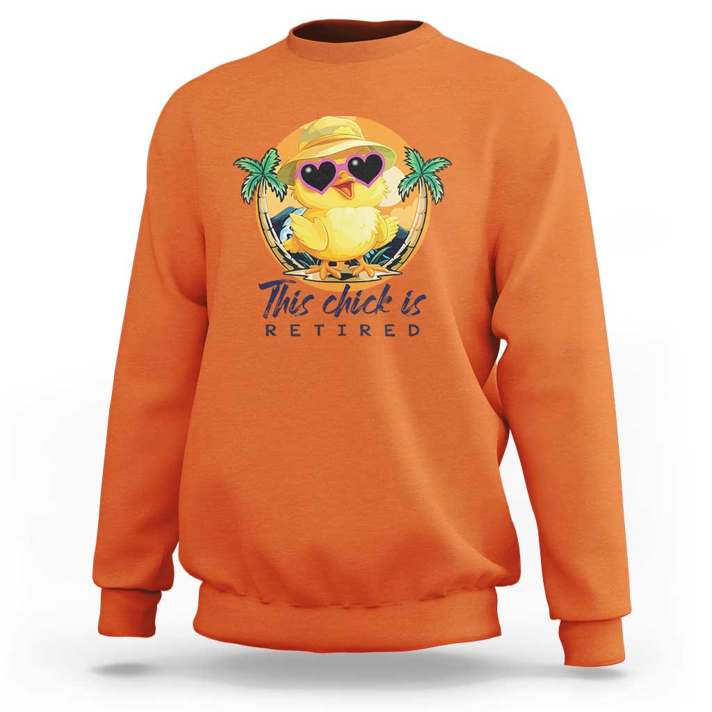 Orange sweatshirt with cartoon chick graphic and 'This chick is retired' print.