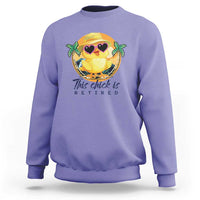 Violet sweatshirt with cartoon chick graphic and 'This chick is retired' print.