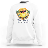 White crewneck sweatshirt with cartoon chick graphic and 'This chick is retired' print.