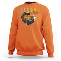 Orange sweatshirt with school bus graphic, crewneck and long sleeves, front view.