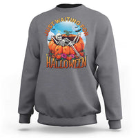 Light gray Halloween sweatshirt with skeleton, pumpkins, and “Halloween” front graphic