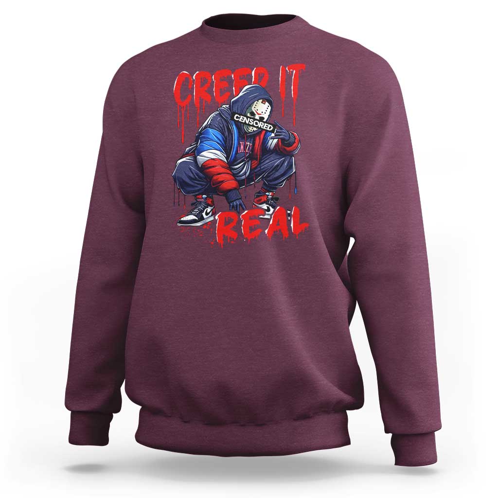 Maroon Halloween horror sweatshirt with 'Creep It Real' graphic front