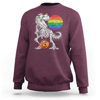 Maroon Halloween sweatshirt with T-Rex skeleton, rainbow moon, and jack-o'-lantern graphic