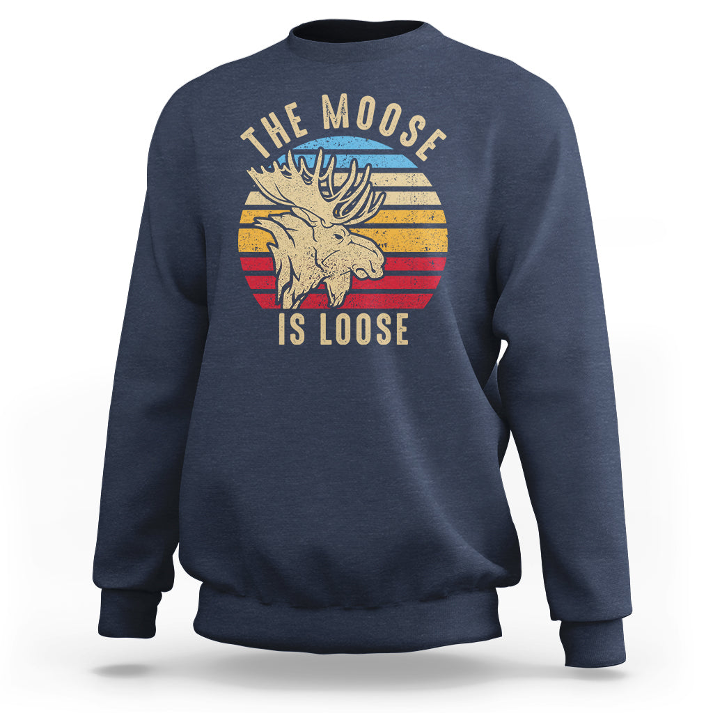 Navy sweatshirt with 'The Moose Is Loose' moose graphic on front.