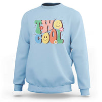 Light blue sweatshirt with colorful “2” birthday graphic, flowers, and smiling face