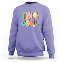 Violet sweatshirt with colorful “2” birthday graphic, flowers, and smiling face