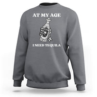 Dark heather gray sweatshirt with 'AT MY AGE I NEED TEQUILA' white print and bottle icon
