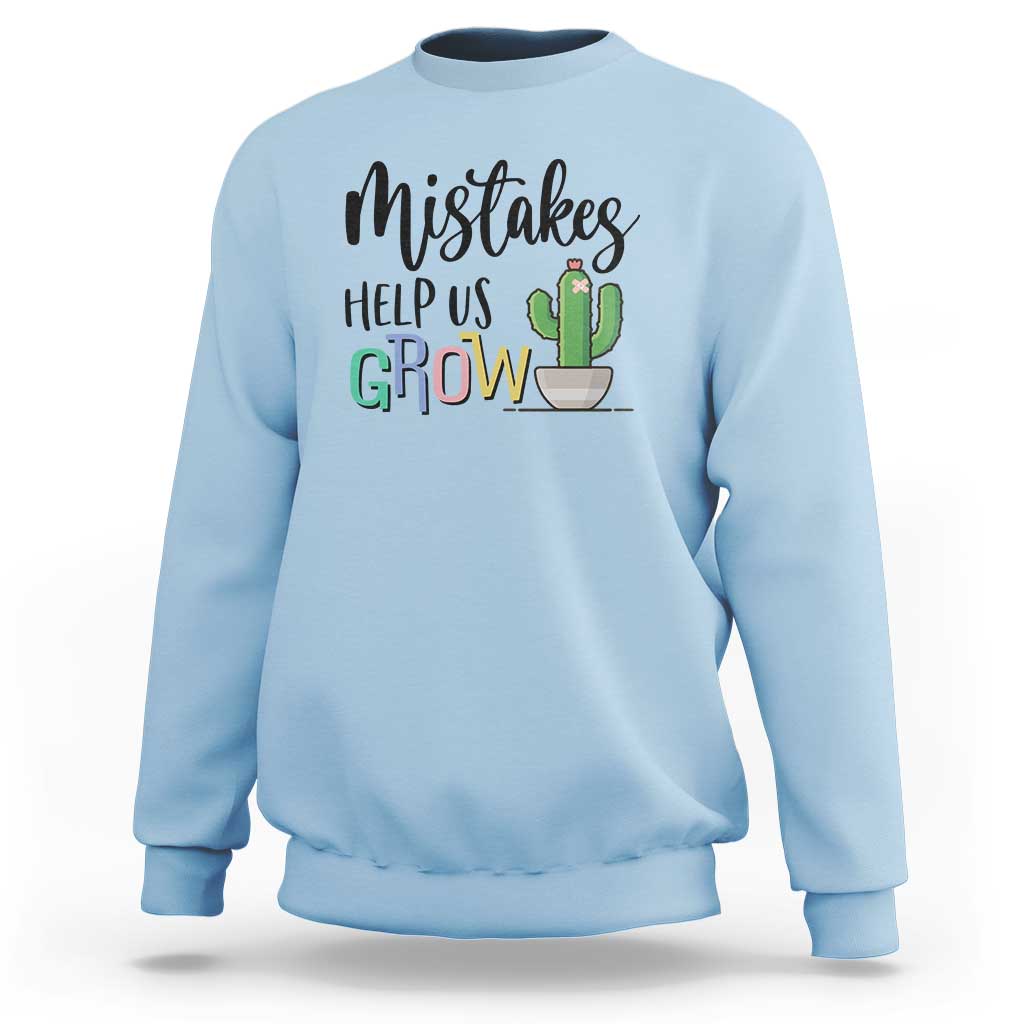 Light blue crewneck sweatshirt with front 'Help Us Grow' cactus graphic.