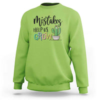 Green crewneck sweatshirt with front 'Help Us Grow' cactus graphic.