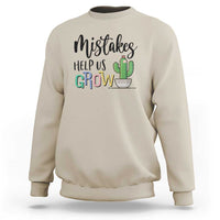 Beige crewneck sweatshirt with front 'Help Us Grow' cactus graphic.