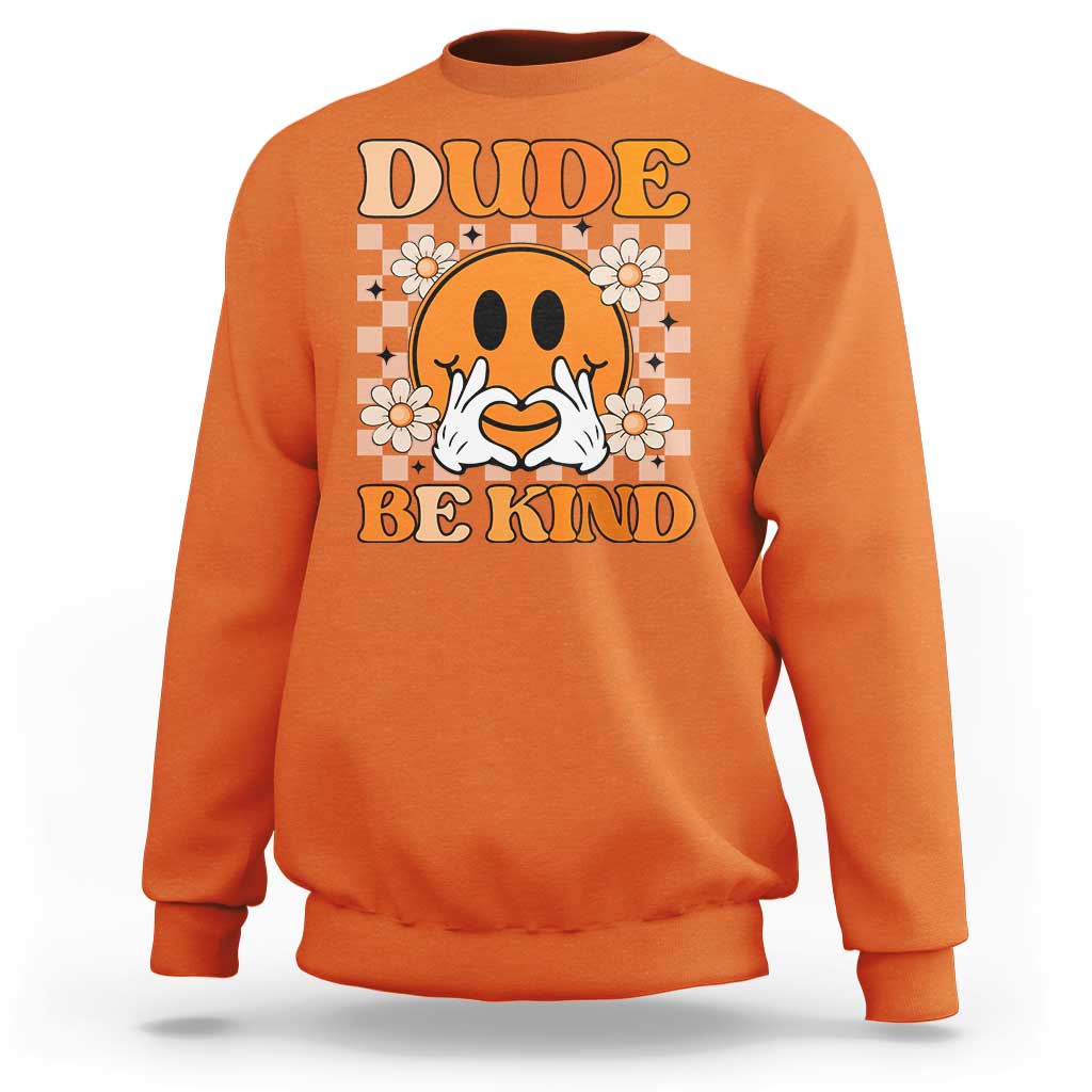 Orange sweatshirt with cartoon dog face graphic and “DUDE” and “BE KIND” text, daisies