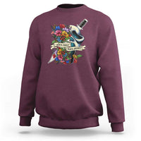 Maroon sweatshirt with floral ghost and knife graphic on the chest