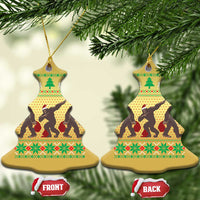 Gold bell-shaped holiday ornaments with Bigfoot squad silhouettes on festive pattern