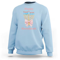 Light blue crewneck sweatshirt with menorah graphic and pink bow at center chest