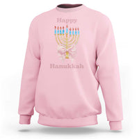 Light pink crewneck sweatshirt with menorah graphic and pink bow at center chest