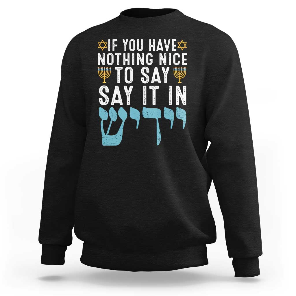 Black Hanukkah sweatshirt with large typographic text graphic on front.