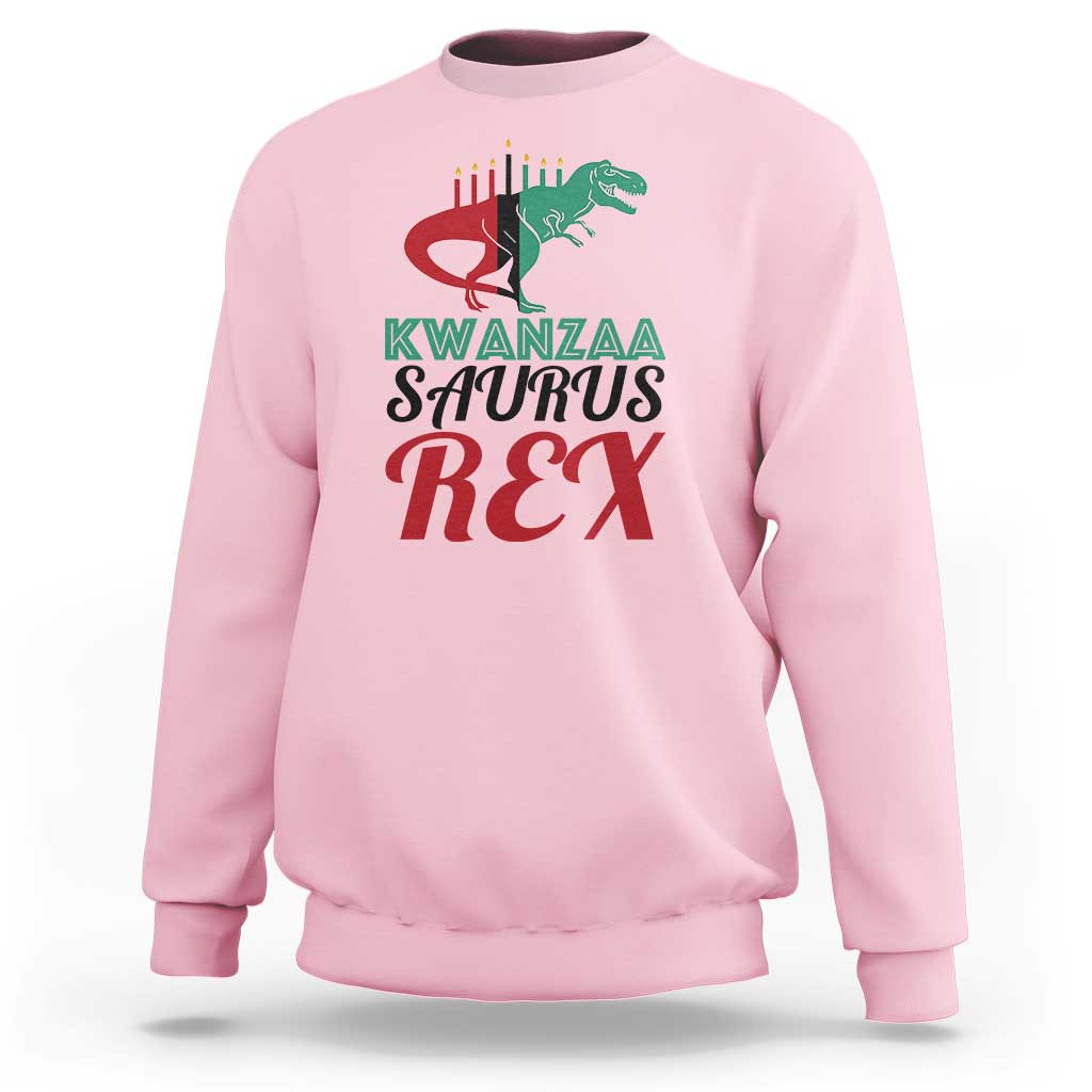 Kwanzaa Saurus Rex sweatshirt, light pink, chest graphic with T-rex and Kwanzaa text.