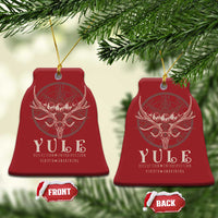 Red bell-shaped Christmas ornaments with gold hanging strings and antlered skull emblem.