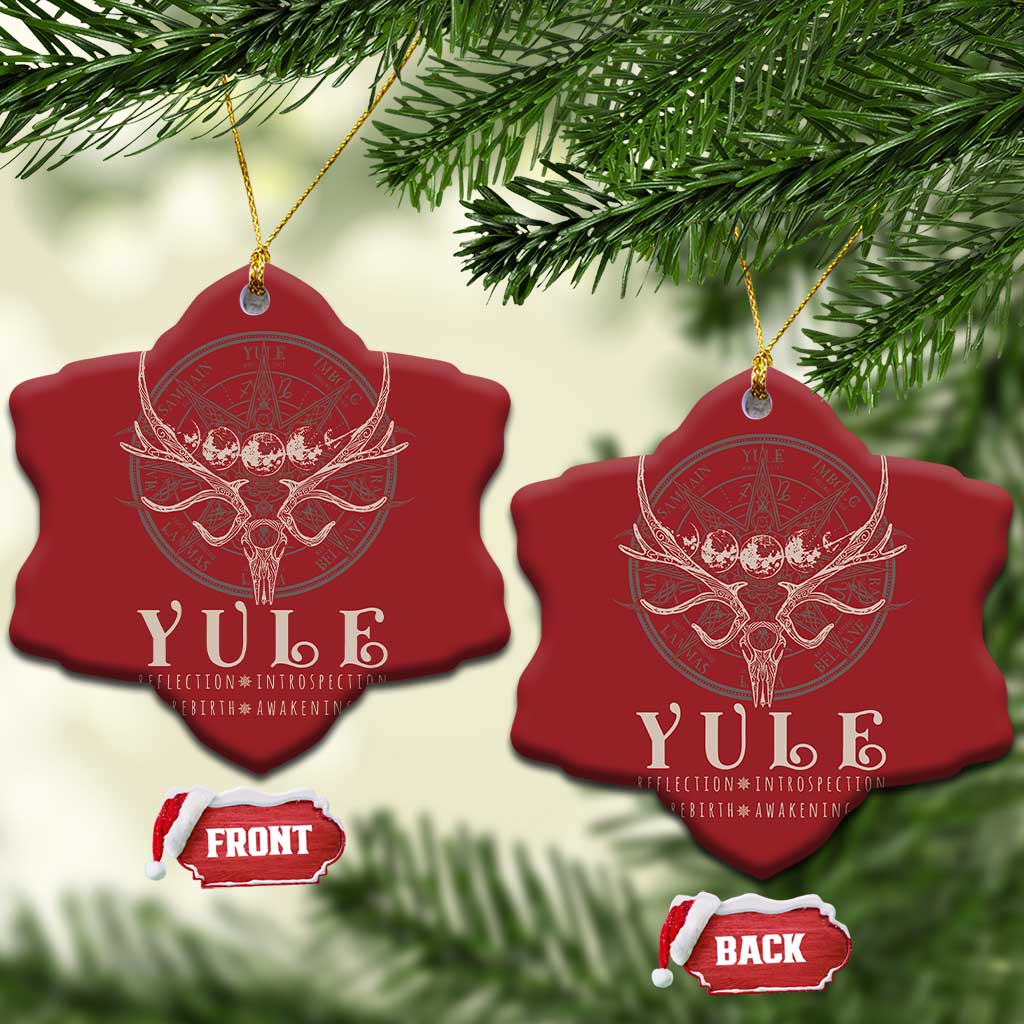 Red starburst-shaped Christmas ornaments with gold hanging strings and antlered skull emblem.