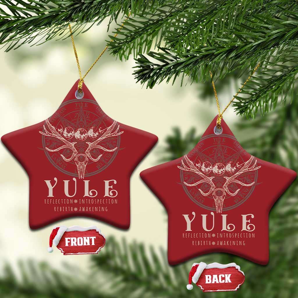 Red star-shaped Christmas ornaments with gold hanging strings and antlered skull emblem.